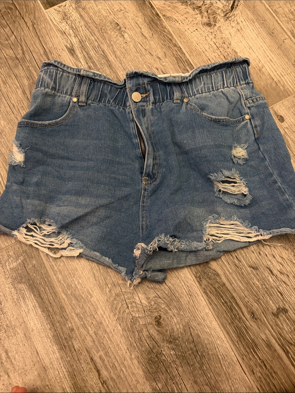 High-Rise Distressed Denim Shorts in Blue